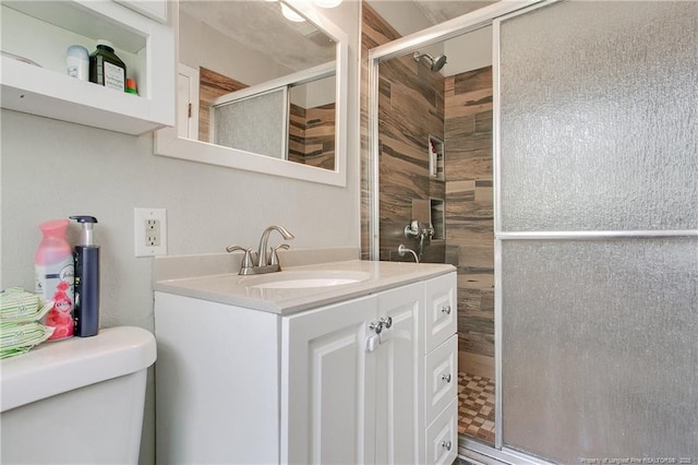 full bath with toilet, a stall shower, and vanity