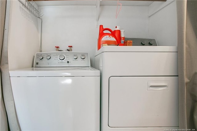clothes washing area featuring laundry area and washing machine and dryer