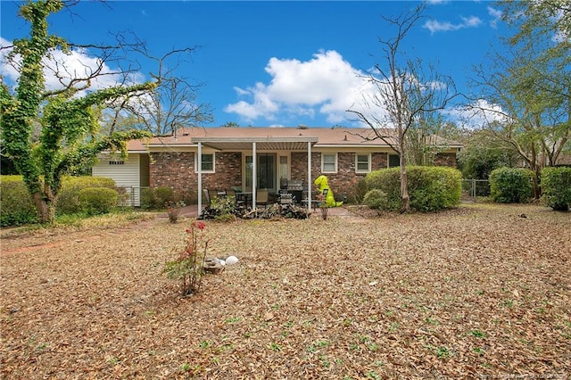 back of property with fence and brick siding