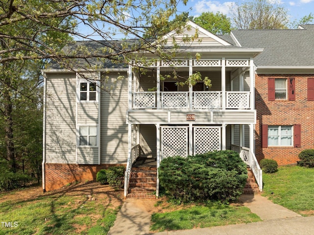 view of front of house featuring a front lawn and stairs