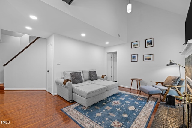 living room with wood finished floors, baseboards, and recessed lighting