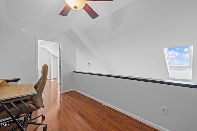 office space featuring ceiling fan, baseboards, vaulted ceiling, and hardwood / wood-style flooring
