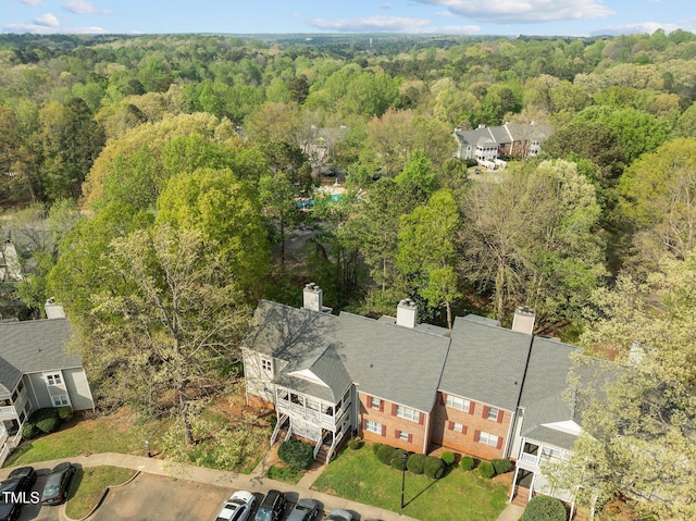 birds eye view of property with a view of trees