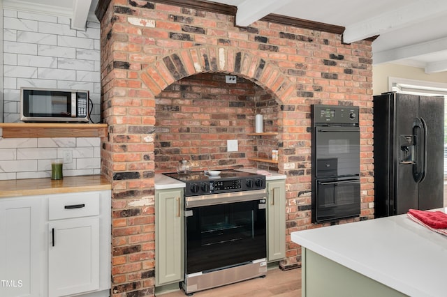kitchen with tasteful backsplash, light countertops, beamed ceiling, black appliances, and light wood finished floors