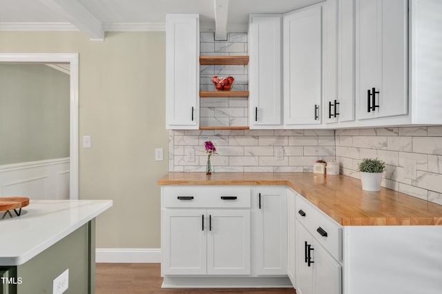 kitchen featuring tasteful backsplash, white cabinetry, open shelves, and wooden counters