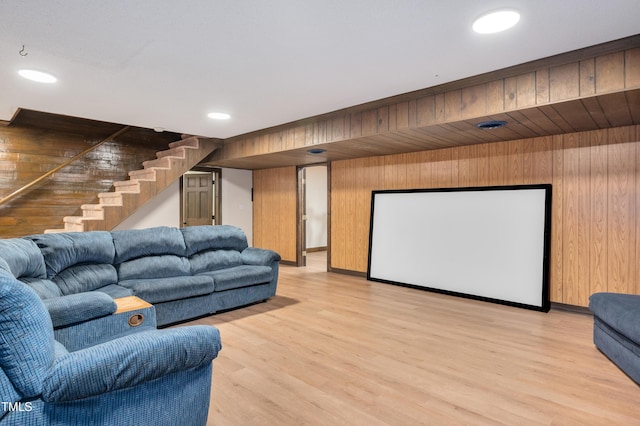 home theater room with wooden walls, light wood-style flooring, and recessed lighting