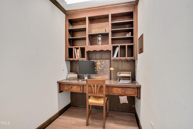 office space featuring baseboards, built in study area, and wood finished floors