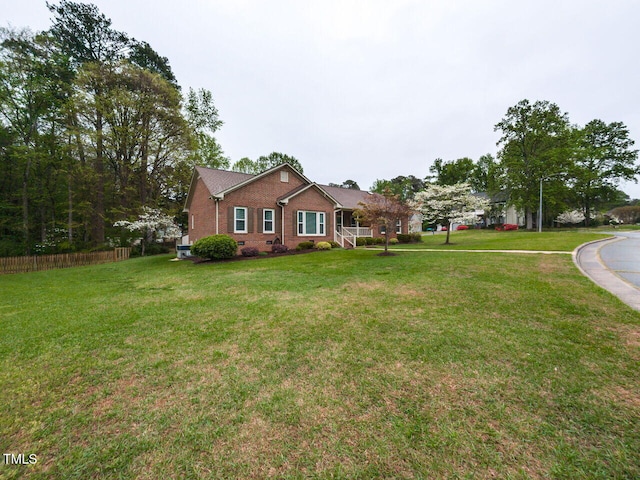 422 Old Scarborough Ln, Garner, NC 27529 - ranch-style home with brick siding, a front lawn, and fence