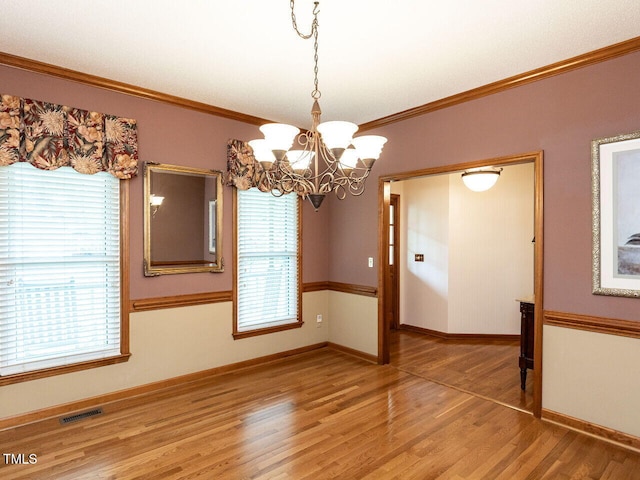 422 Old Scarborough Ln, Garner, NC 27529 - unfurnished dining area with a notable chandelier, light wood finished floors, visible vents, and ornamental molding