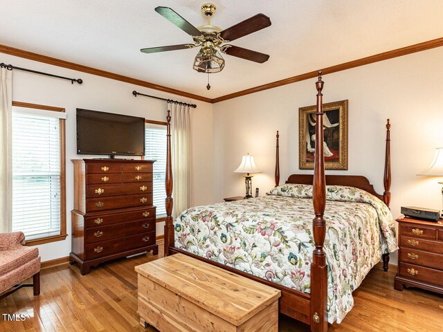 422 Old Scarborough Ln, Garner, NC 27529 - bedroom featuring baseboards, crown molding, a ceiling fan, and wood finished floors