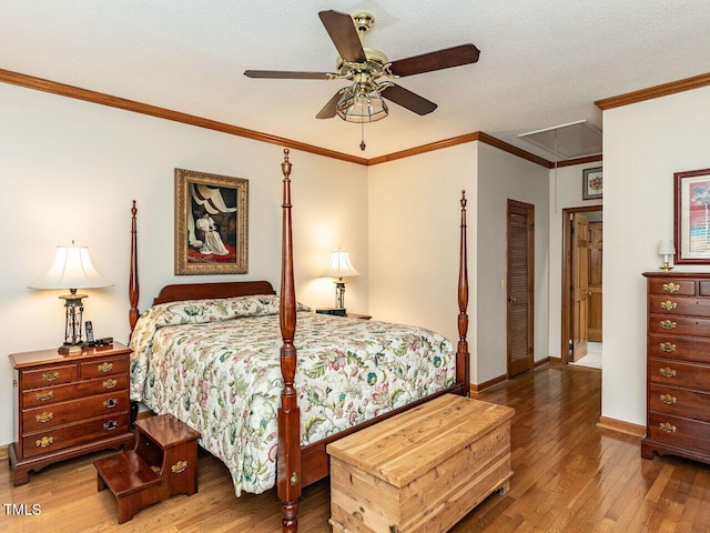 422 Old Scarborough Ln, Garner, NC 27529 - bedroom with baseboards, ornamental molding, a textured ceiling, attic access, and wood finished floors
