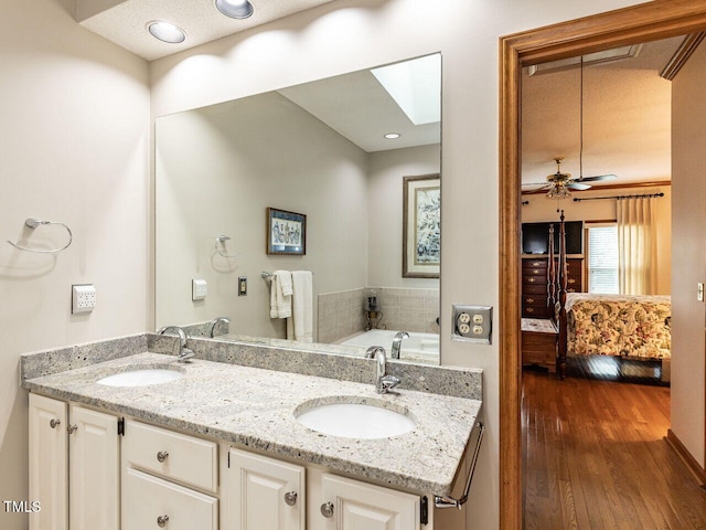 422 Old Scarborough Ln, Garner, NC 27529 - ensuite bathroom with wood finished floors, double vanity, a sink, and connected bathroom