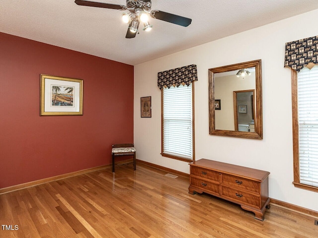 422 Old Scarborough Ln, Garner, NC 27529 - empty room featuring plenty of natural light, light wood-style flooring, baseboards, and ceiling fan