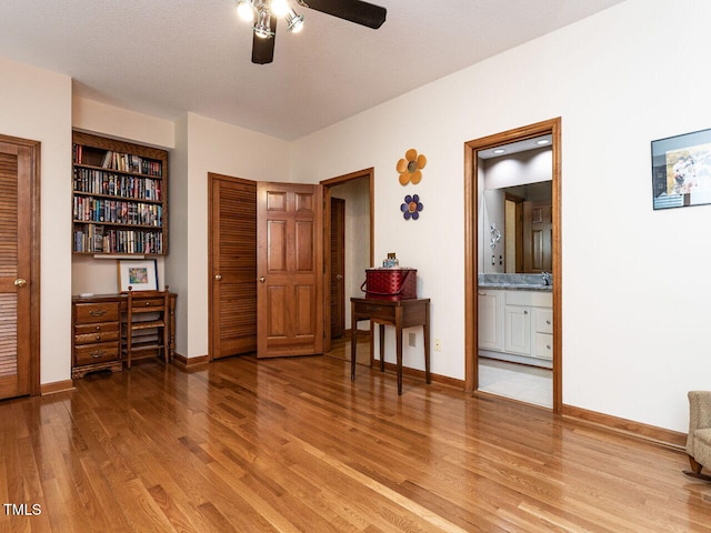 422 Old Scarborough Ln, Garner, NC 27529 - bedroom with a closet, ensuite bathroom, light wood-type flooring, and baseboards