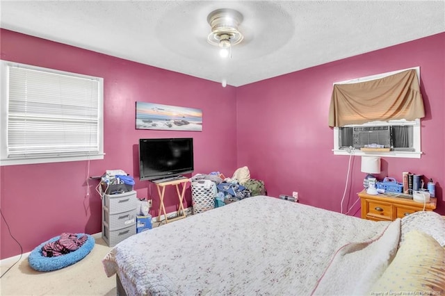 bedroom featuring cooling unit and ceiling fan