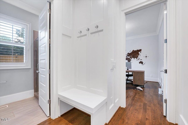 mudroom with ornamental molding, baseboards, and dark wood-style floors