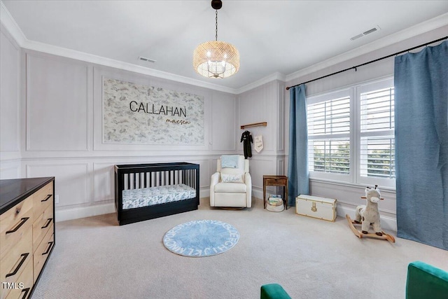 bedroom with crown molding, a decorative wall, carpet flooring, and visible vents