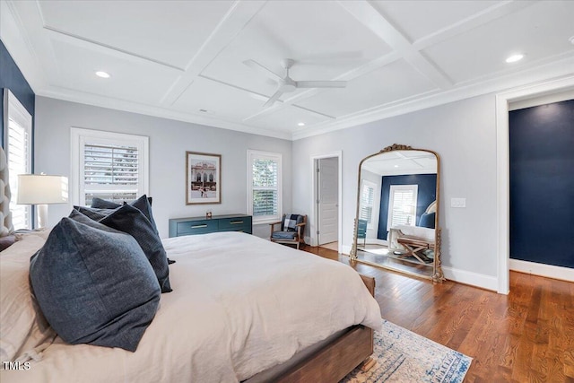 bedroom featuring coffered ceiling, crown molding, wood finished floors, and baseboards