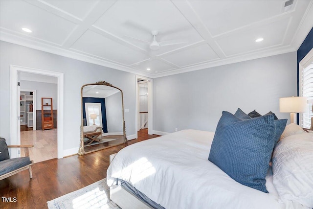 bedroom featuring multiple windows, wood finished floors, and coffered ceiling