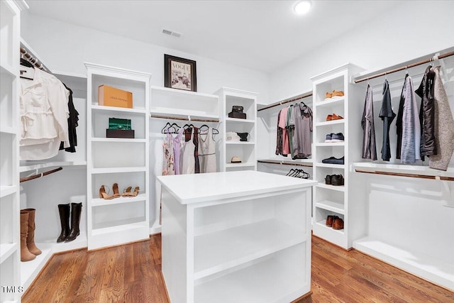 walk in closet featuring wood finished floors and visible vents