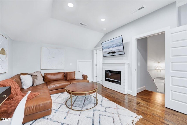 living room featuring visible vents, recessed lighting, wood finished floors, and lofted ceiling