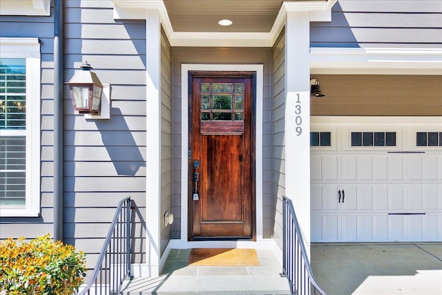 view of exterior entry with a garage