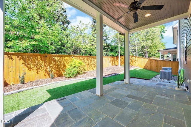 view of patio with central air condition unit, a fenced backyard, and ceiling fan