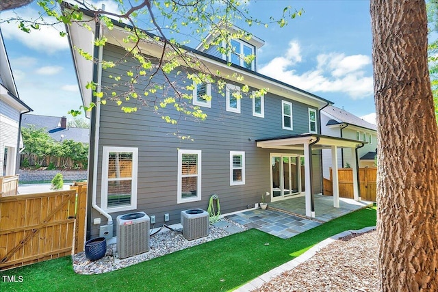 back of property featuring a patio area, central AC, and fence