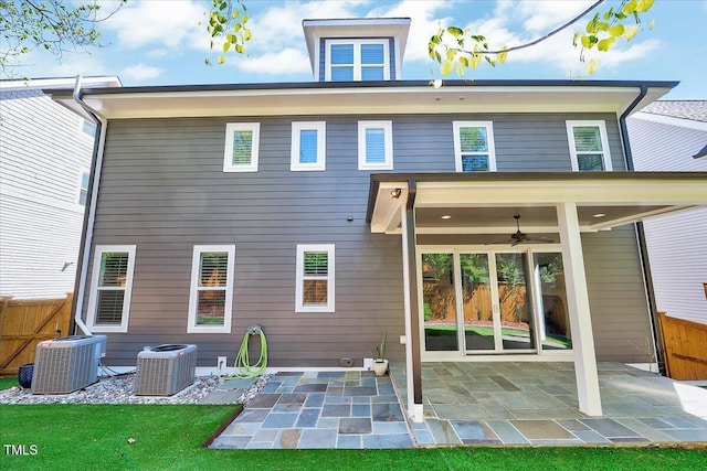 back of house with central AC unit, fence, and a patio