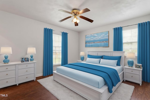 1813 Grady Dr, Durham, NC 27712 - bedroom with dark wood-style flooring, multiple windows, and a ceiling fan