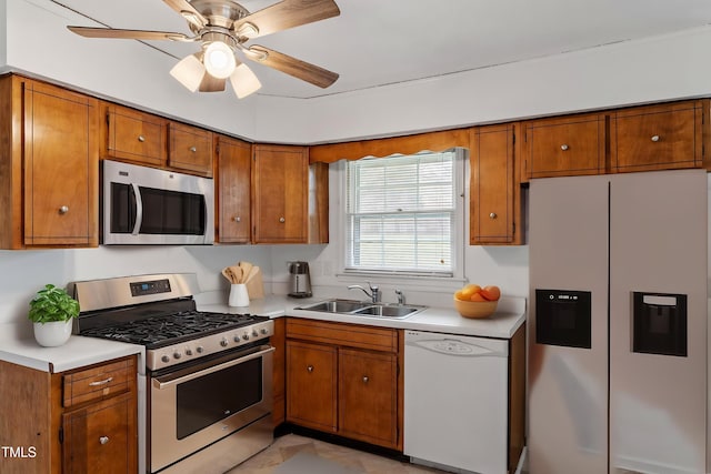 1813 Grady Dr, Durham, NC 27712 - kitchen featuring stainless steel appliances, brown cabinetry, a sink, light countertops, and a ceiling fan