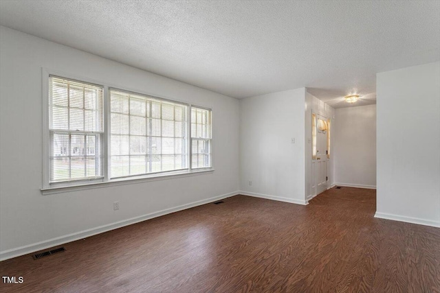 1813 Grady Dr, Durham, NC 27712 - unfurnished room with wood finished floors, a textured ceiling, and healthy amount of natural light