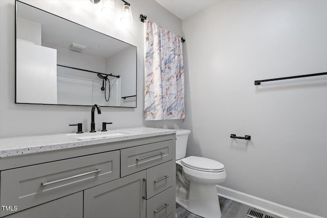 1813 Grady Dr, Durham, NC 27712 - full bathroom with vanity, wood finished floors, and a shower