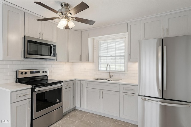 1813 Grady Dr, Durham, NC 27712 - kitchen with stainless steel appliances, light countertops, decorative backsplash, a ceiling fan, and light tile patterned floors