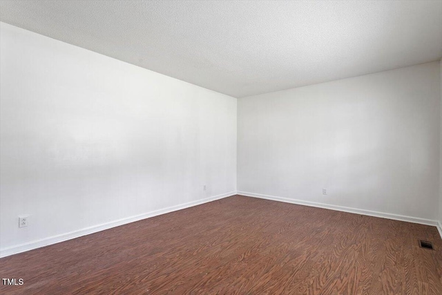 1813 Grady Dr, Durham, NC 27712 - spare room with dark wood-type flooring and baseboards