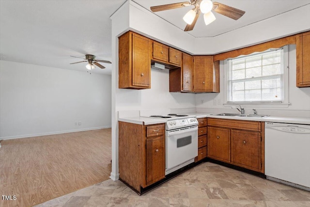 1813 Grady Dr, Durham, NC 27712 - kitchen with white appliances, a ceiling fan, brown cabinets, light countertops, and under cabinet range hood
