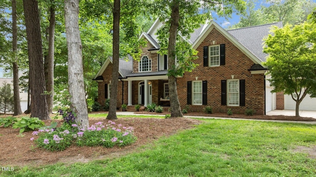 5916 Two Pines Trl, Wake Forest, NC 27587 - view of front of property featuring a front yard, brick siding, covered porch, and roof with shingles