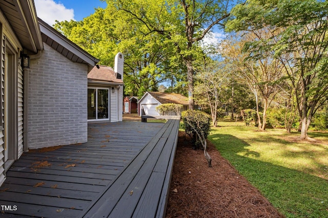 wooden terrace with an outbuilding and a lawn