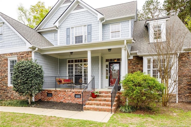 308 St Martins Pl, Fayetteville, NC 28311 - view of front of house with a porch, a shingled roof, and stone siding