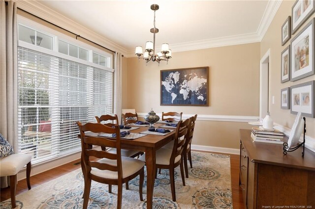 308 St Martins Pl, Fayetteville, NC 28311 - dining room with crown molding, a wealth of natural light, an inviting chandelier, and wood finished floors