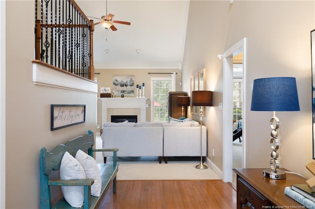 308 St Martins Pl, Fayetteville, NC 28311 - living area featuring a fireplace, light wood-style flooring, ornamental molding, a ceiling fan, and baseboards