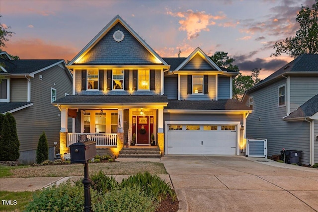 craftsman house featuring covered porch, concrete driveway, and a garage
