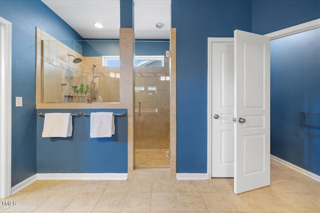 bathroom featuring a stall shower, baseboards, and tile patterned floors