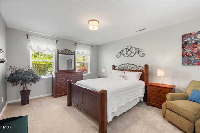 bedroom featuring light colored carpet and baseboards