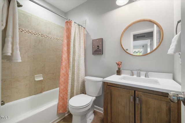 bathroom with toilet, wood finished floors, vanity, and shower / tub combo