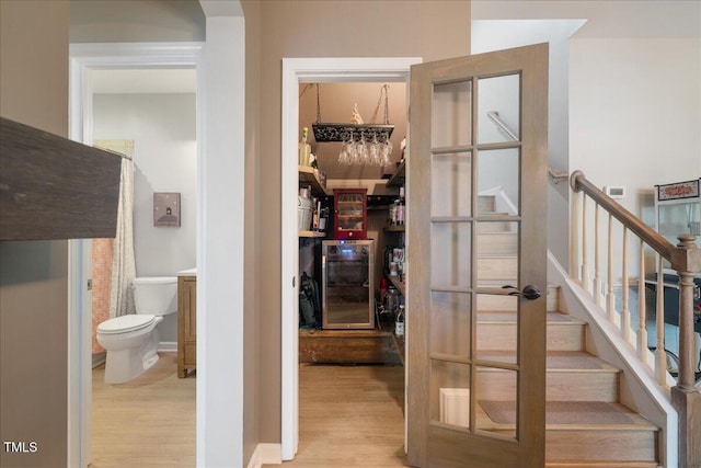 wine cellar featuring wood finished floors and beverage cooler