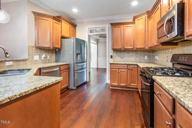 2106 Cloud Cover Ln, Raleigh, NC 27614 - kitchen with light stone counters, a sink, stainless steel appliances, ornamental molding, and dark wood-style floors