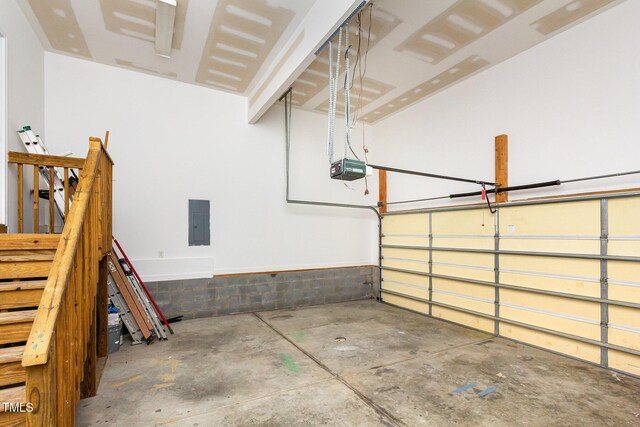 2106 Cloud Cover Ln, Raleigh, NC 27614 - garage featuring electric panel and a garage door opener