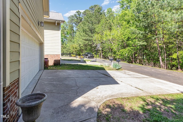 2106 Cloud Cover Ln, Raleigh, NC 27614 - view of patio / terrace featuring a garage and driveway