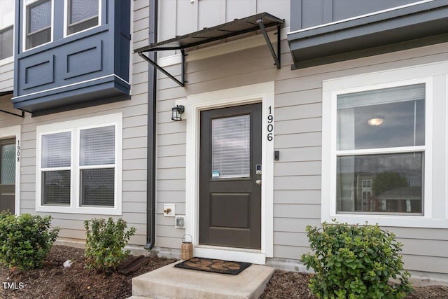 view of exterior entry featuring board and batten siding